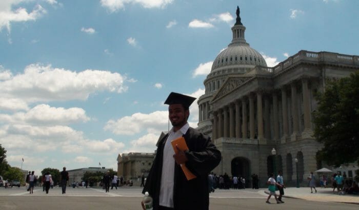 Graduate in front of the capital building, Photo by America’s Voice.