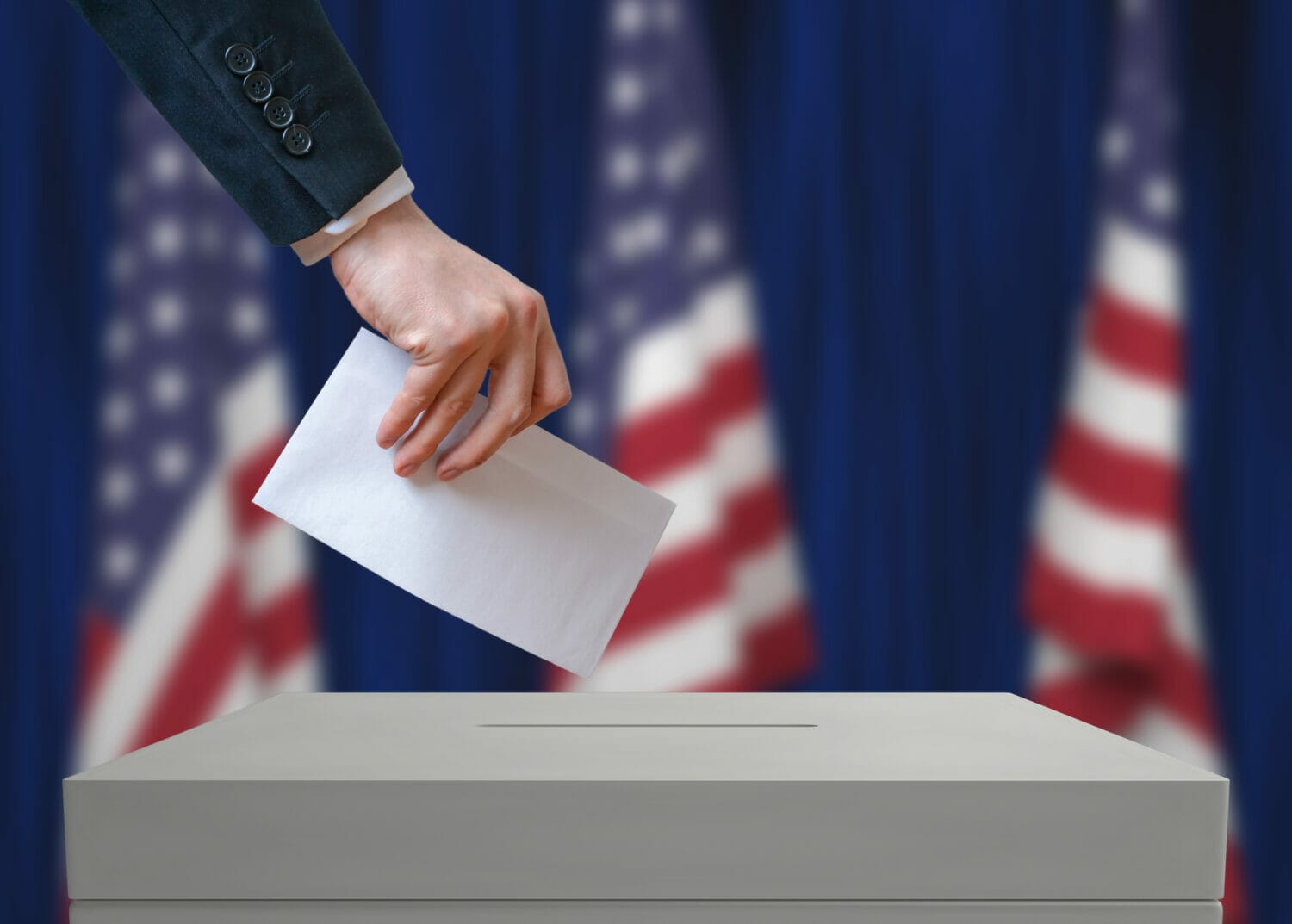 Person casting a vote at the ballot box