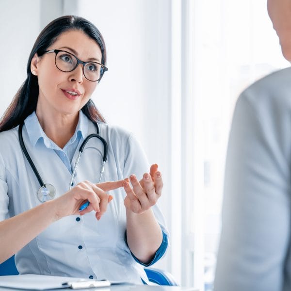 A doctor perform an immigration medical exam.