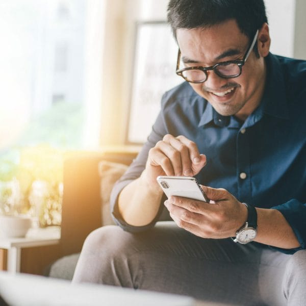 An immigrant looks for work using an app.