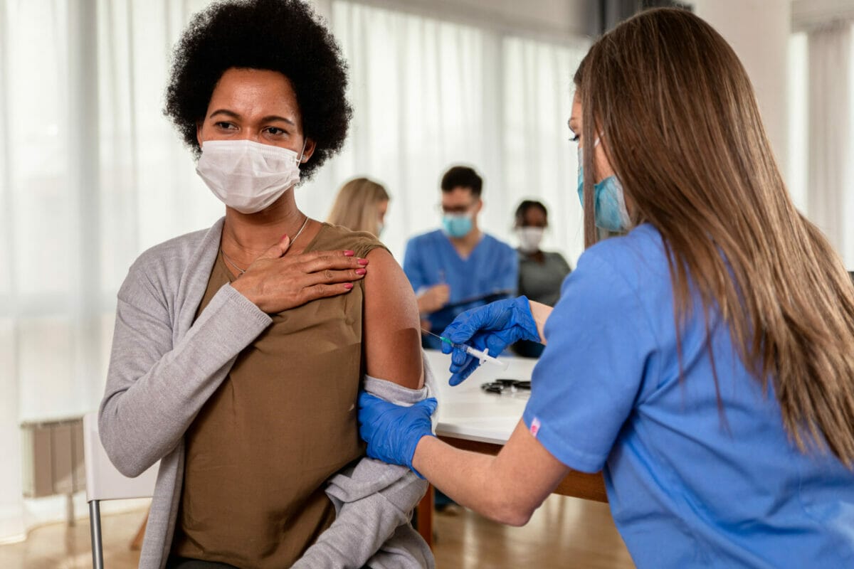An immigrant gets a covid-19 vaccine