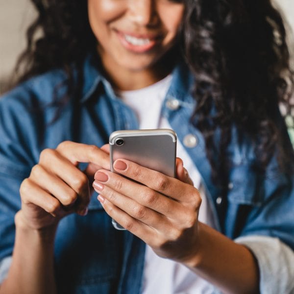 An immigrant looks at a language app on her phone.