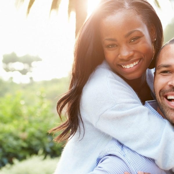 A couple hugging and laughing together.