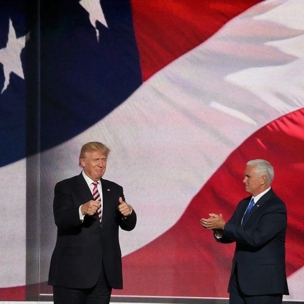 President Trump clapping onstage with VP Mike Pence