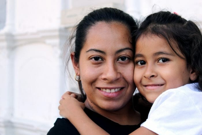 A mother and daughter smile for the camera.