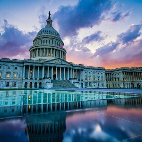 Sunset U.S. Capitol in Washington DC with the reflecting pool in foreground
