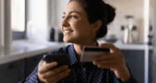 An immigrant holding a credit card.